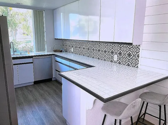 a kitchen with a sink a window and cabinets