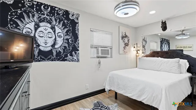 a bedroom with a bed and a chandelier