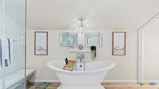 a white bath tub sitting next to a white sink