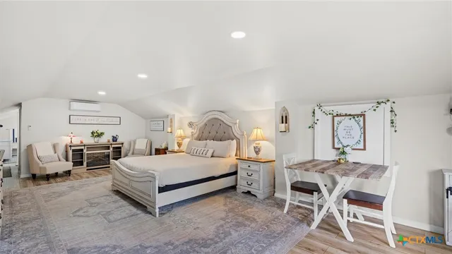 a spacious bedroom with a bed a table and chair