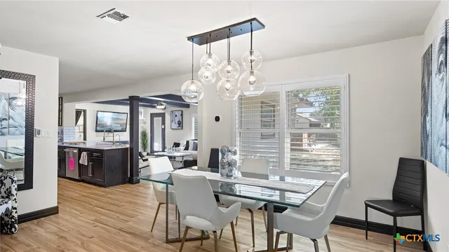 a view of a dining room with furniture window and wooden floor