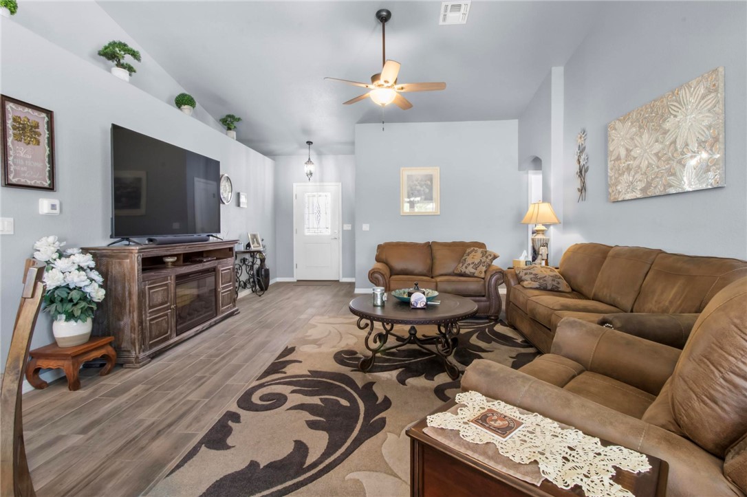 3897 Easy Street Kingman, AZ 86409 - Photo 8 of 53 a living room with furniture a flat screen tv and a fireplace