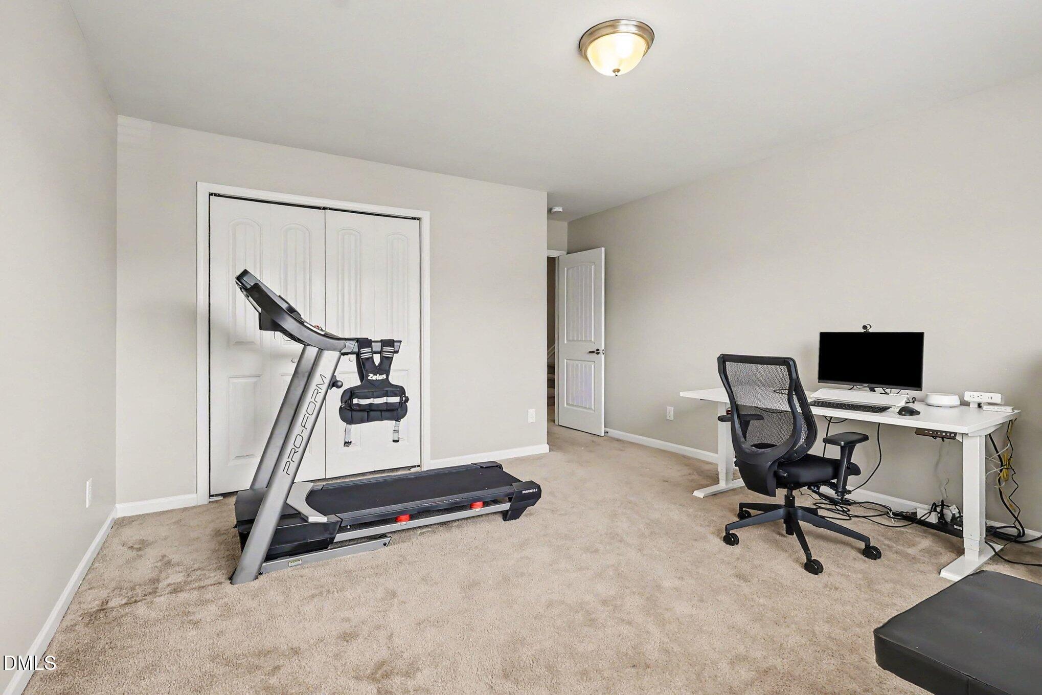 4366 Auburn Hills Drive Raleigh, NC 27616 - Photo 23 of 40 a view of a workspace with gym equipment