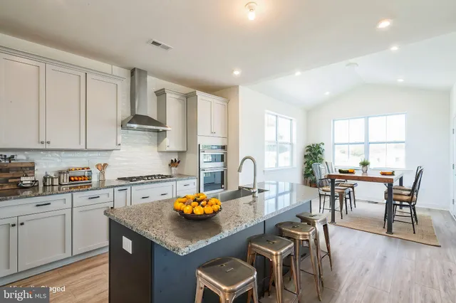 a kitchen with a table chairs stove and cabinets