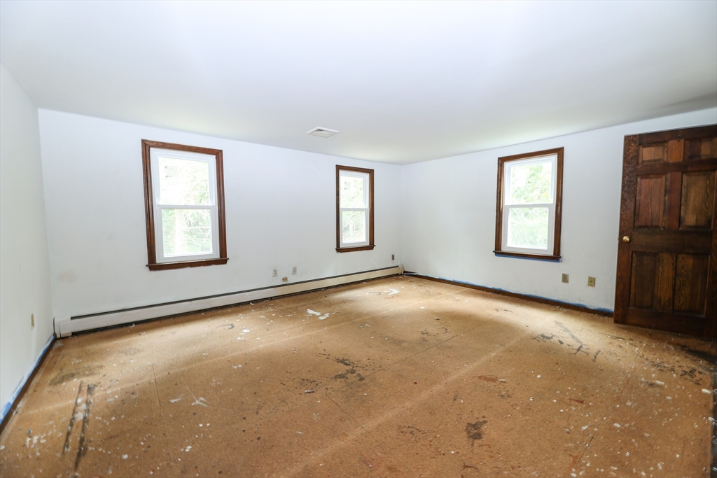 329 Woodside Road Barnstable, MA 02668 - Photo 11 of 26 an empty room with windows and fireplace