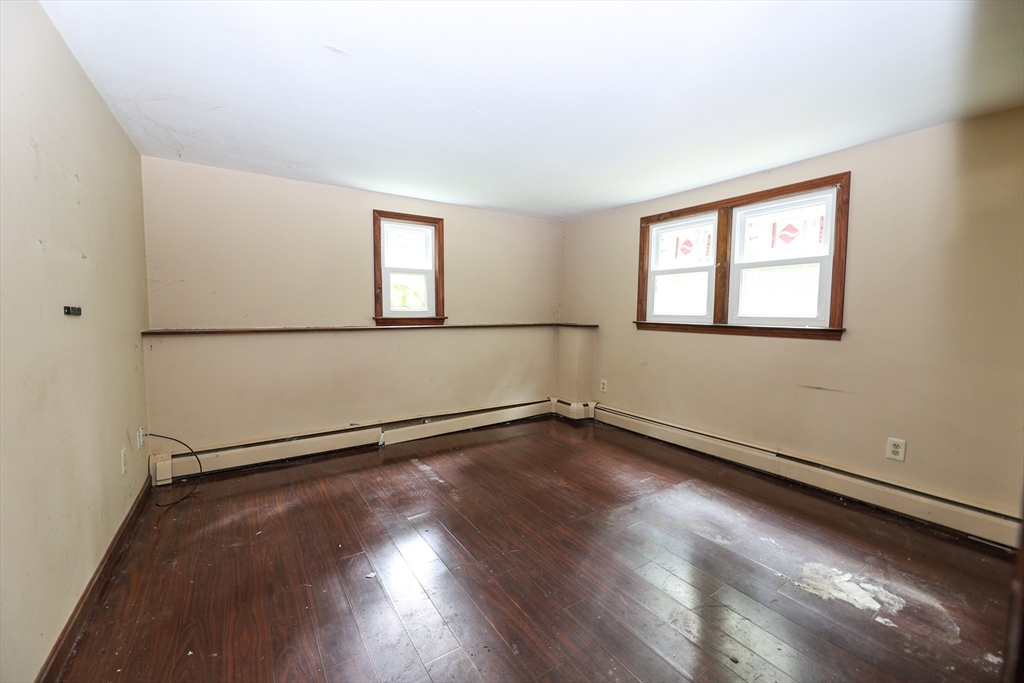 329 Woodside Road Barnstable, MA 02668 - Photo 13 of 26 an empty room with wooden floor and windows