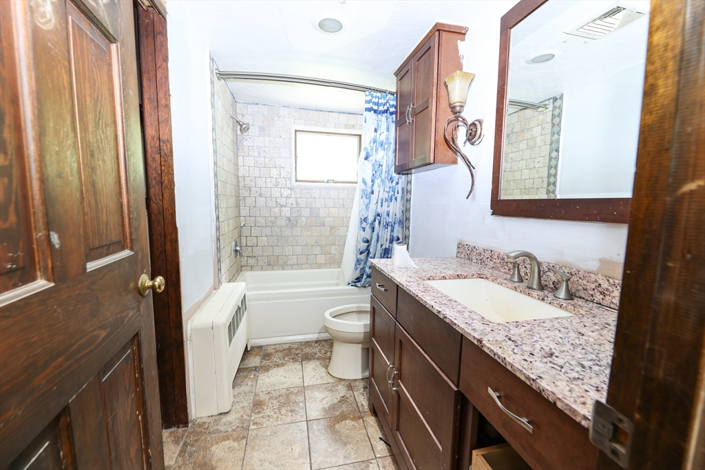 329 Woodside Road Barnstable, MA 02668 - Photo 22 of 26 a bathroom with a granite countertop sink toilet and shower