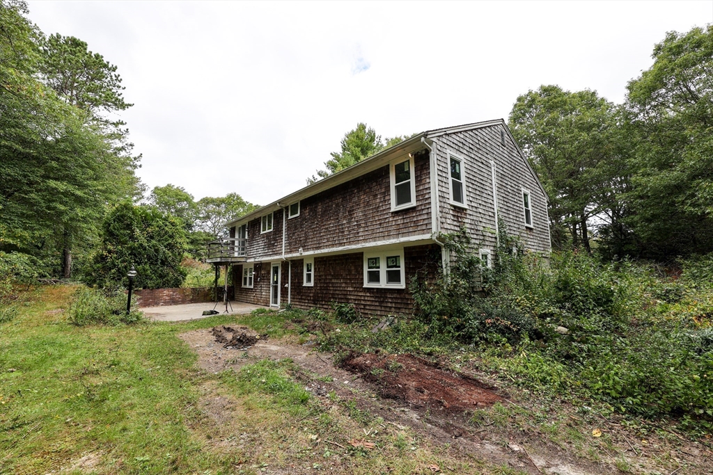 329 Woodside Road Barnstable, MA 02668 - Photo 23 of 26 a backyard of a house with lots of green space