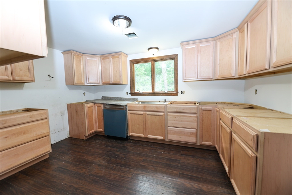 329 Woodside Road Barnstable, MA 02668 - Photo 6 of 26 a kitchen with white cabinets sink and window