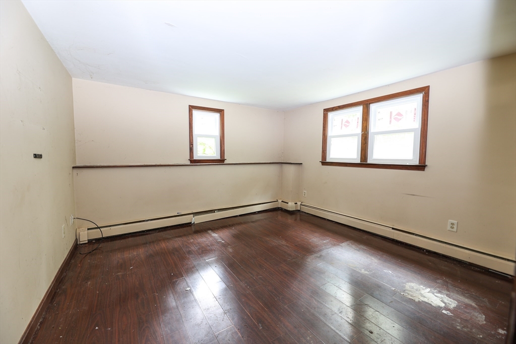 329 Woodside Road Barnstable, MA 02668 - Photo 8 of 26 an empty room with wooden floor and windows