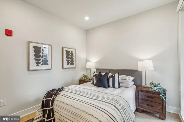 a bedroom with a bed and a lamp