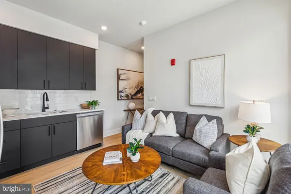a living room with a couch and a sink