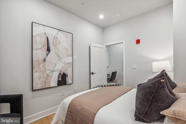 a bedroom with a bed and a window