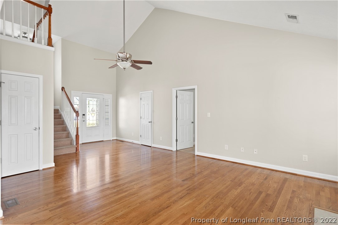132 Rockingham Street Spring Lake, NC 28390 - Photo 8 of 24 a view of an empty room with wooden floor and a ceiling fan