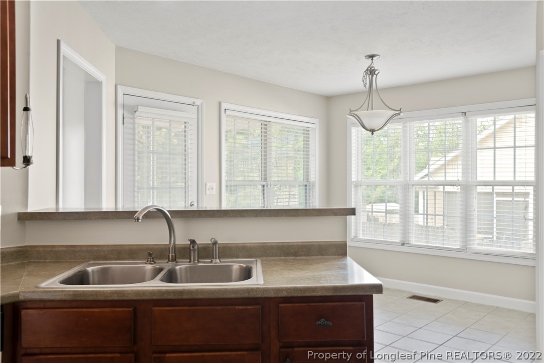 132 Rockingham Street Spring Lake, NC 28390 - Photo 10 of 24 a kitchen with a sink a counter cabinets and appliances