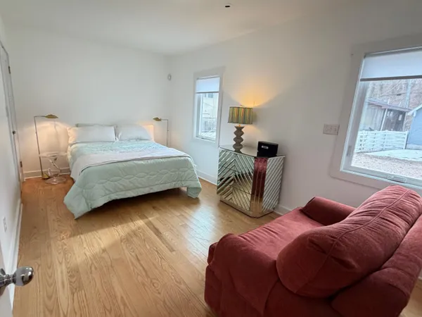 a bedroom with bed and a couch