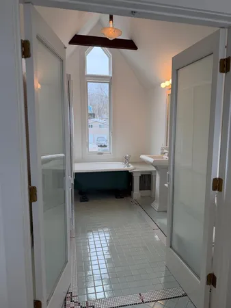 a view of an empty room with a fireplace and a mirror