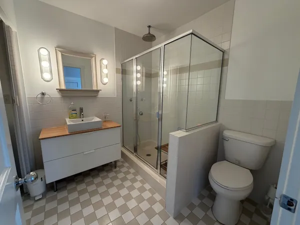 a bathroom with a sink a toilet and shower