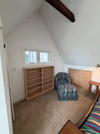 a living room with furniture and a bed