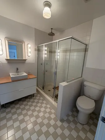 a bathroom with a toilet sink and mirror