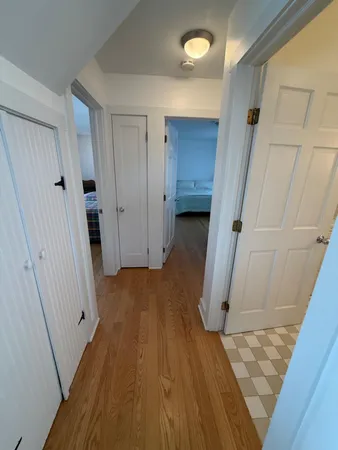 a view of a room with wooden floor and staircase