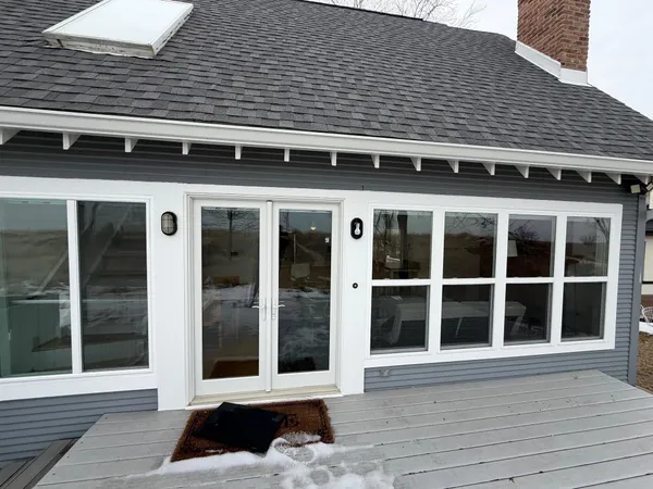 a view of a brick house with large windows