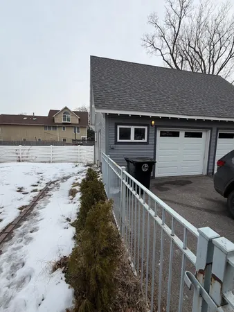 a view of large house with snow on the road