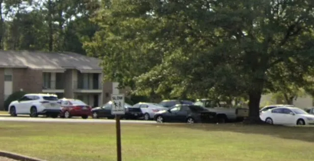 a couple of cars parked in front of a house