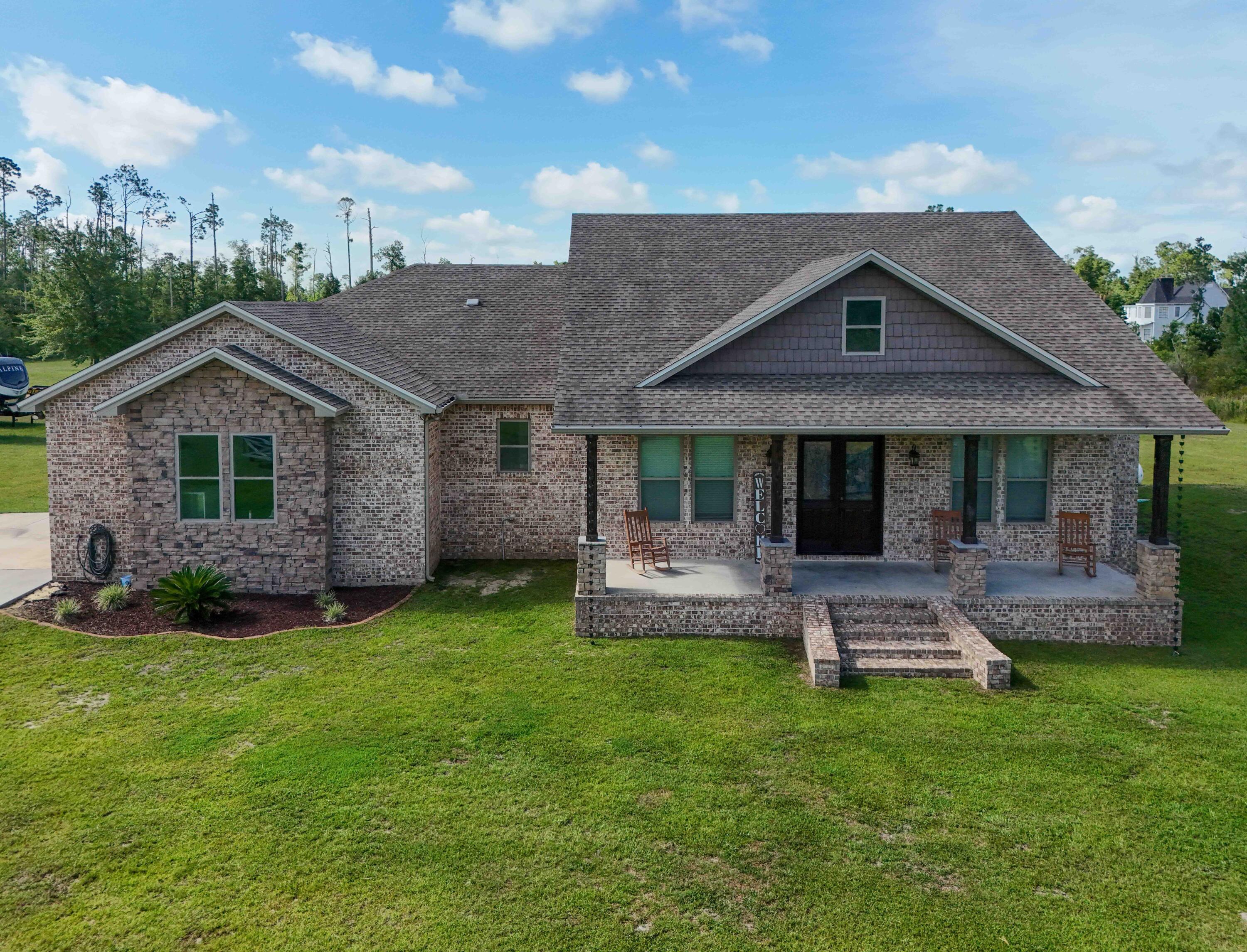 2750 Edwards Road Southport, FL 32409 - Photo 15 of 60 a front view of a house with a garden and patio