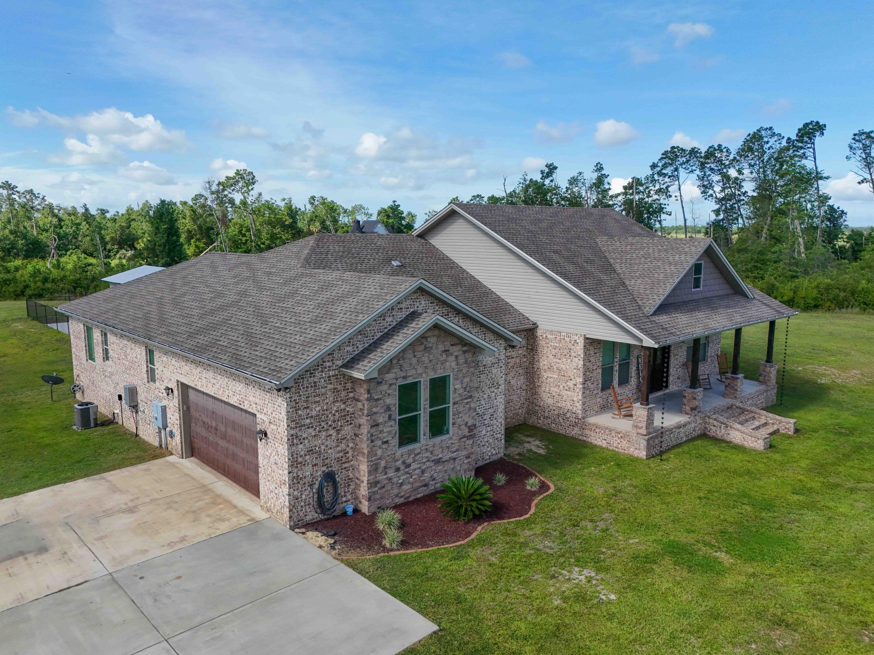 2750 Edwards Road Southport, FL 32409 - Photo 16 of 60 a aerial view of a house with a yard potted plants and a bench