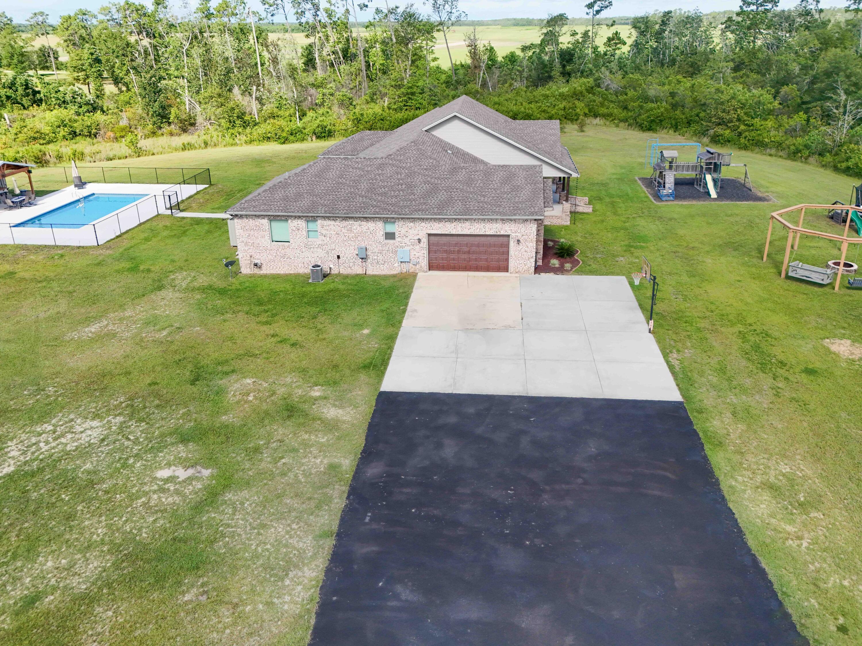 2750 Edwards Road Southport, FL 32409 - Photo 20 of 60 a aerial view of a house with a yard