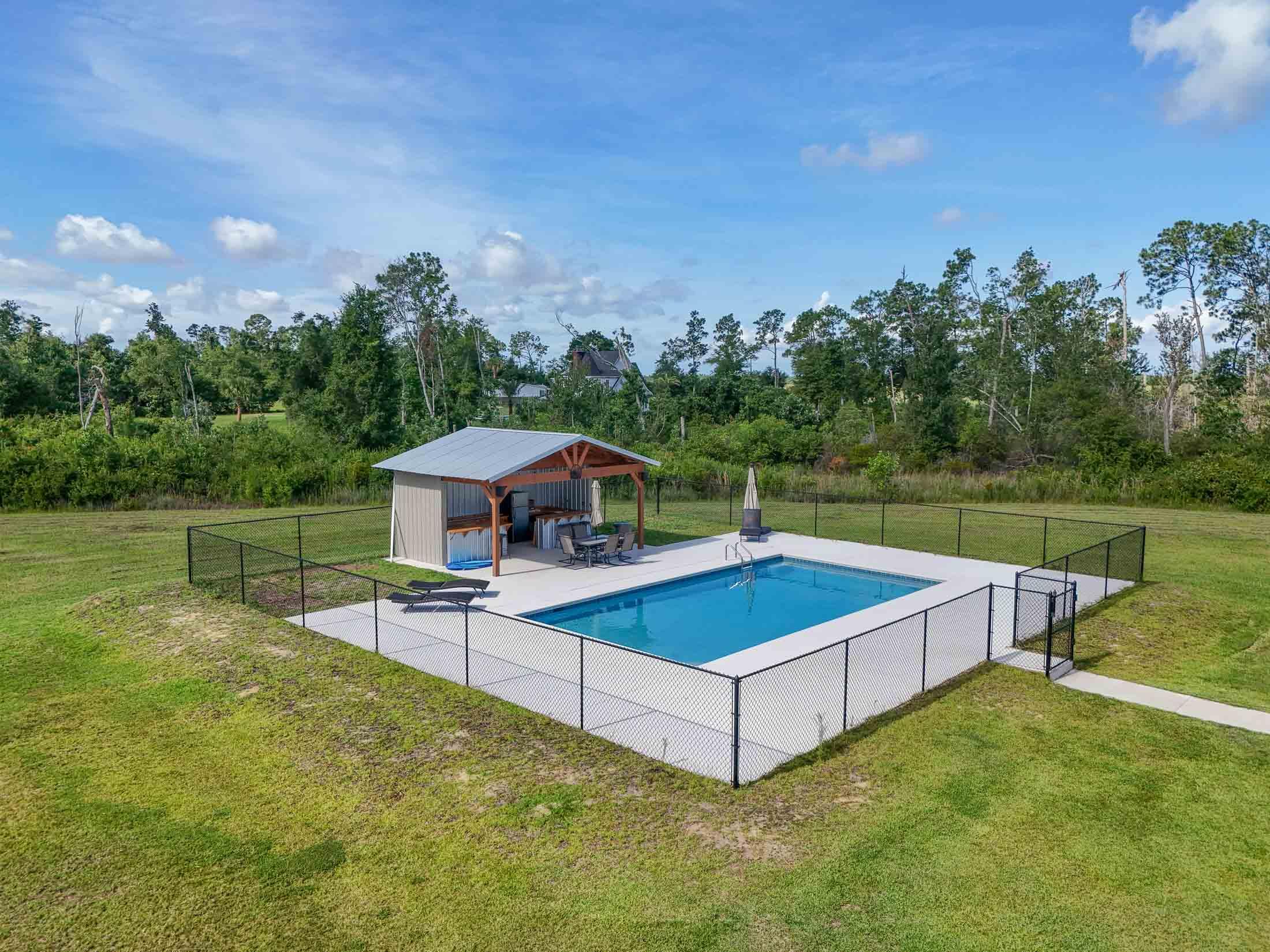 2750 Edwards Road Southport, FL 32409 - Photo 5 of 60 a view of a swimming pool with a yard and sitting area
