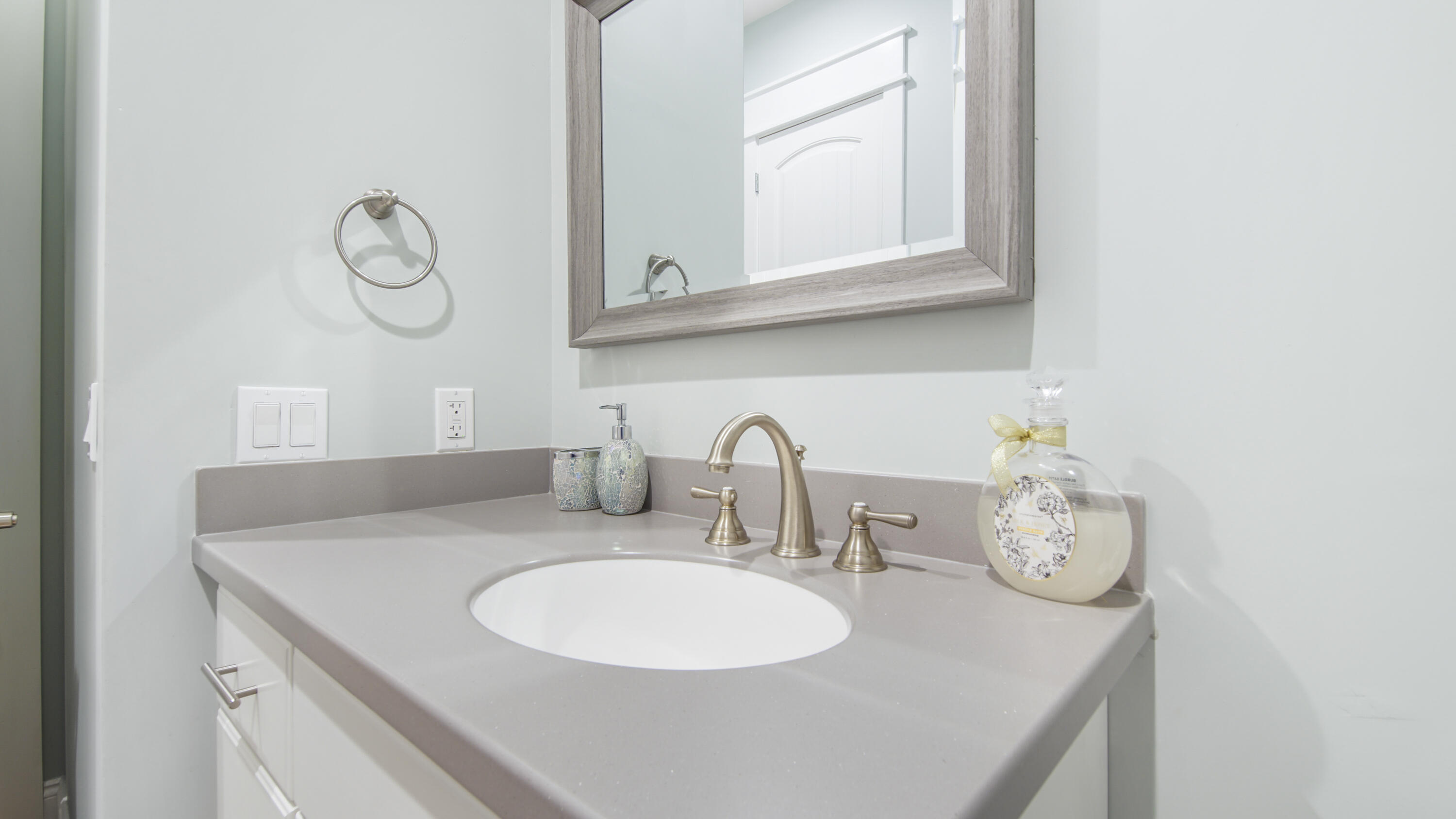 2750 Edwards Road Southport, FL 32409 - Photo 54 of 60 a bathroom with a granite countertop sink and a mirror