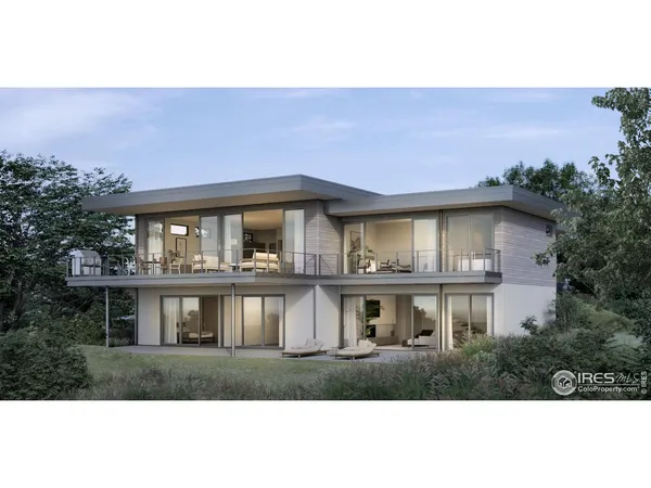 a front view of house with yard and trees in the background