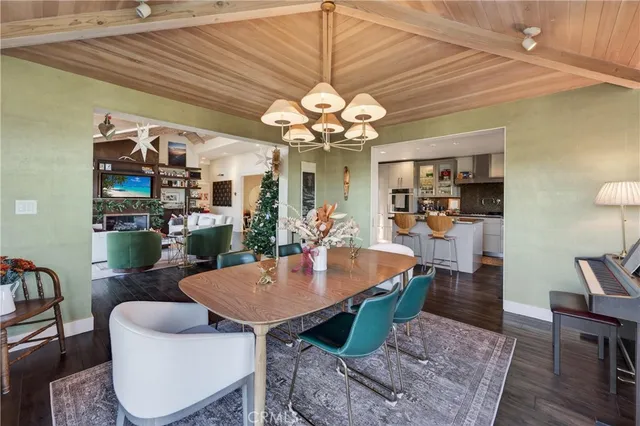 a kitchen with a stove a sink dishwasher a refrigerator and microwave with wooden floor