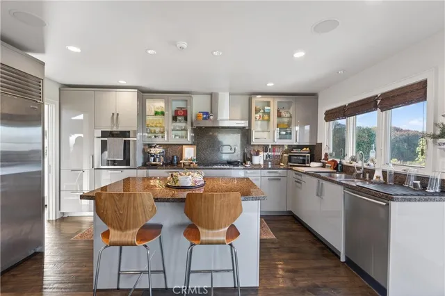 a kitchen with stainless steel appliances granite countertop a sink and cabinets