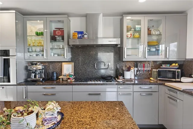 a kitchen with granite countertop a stove and a refrigerator