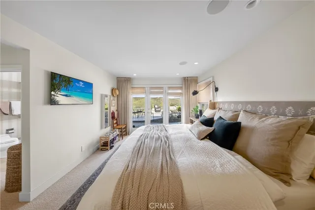 a bedroom with a bed and a flat screen tv