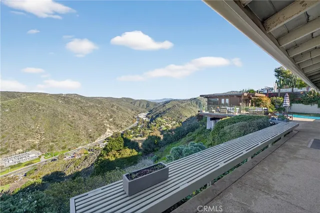 a view of a patio with couches table and chairs and potted plants