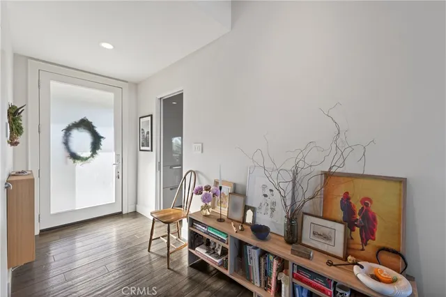 a living room with furniture a flat screen tv and a floor to ceiling window