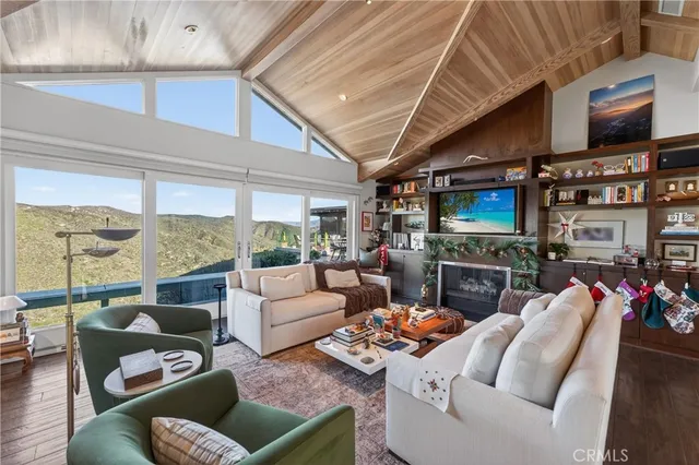 a living room with furniture and a floor to ceiling window