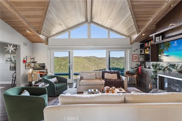 a living room with furniture a rug and a chandelier