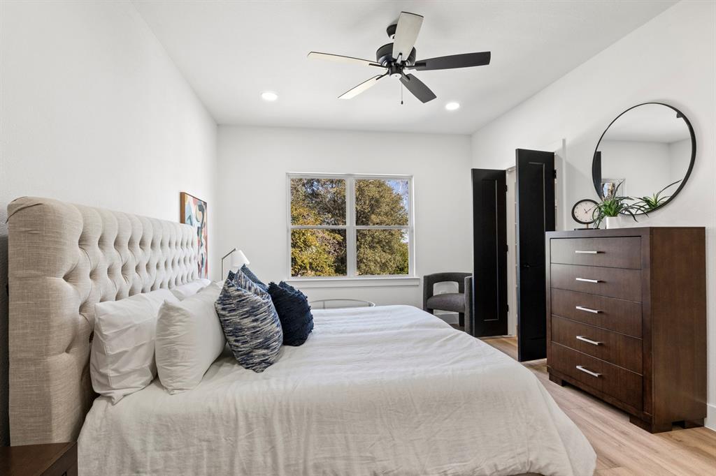 196 West 17th Street Mount Pleasant, TX 75455 - Photo 21 of 35 a bedroom with a large bed and a mirror