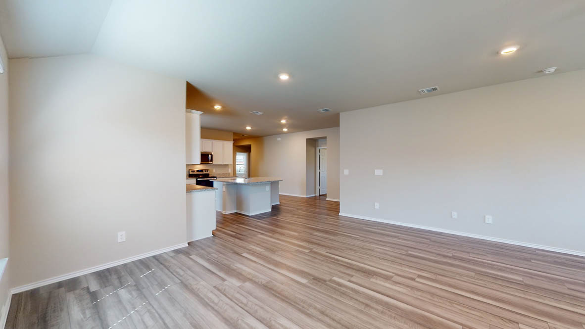 509 Hector Loop Georgetown, TX 78626 - Photo 29 of 31 An open floorplan seamlessly connects the kitchen and living areas, highlighted by attractive hardwood flooring.