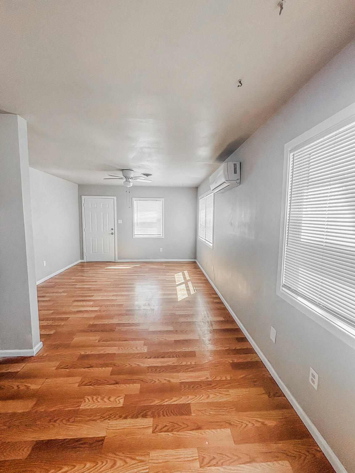 505 East 37th Street Lubbock, TX 79404 - Photo 11 of 25 a view of empty room with wooden floor and fan