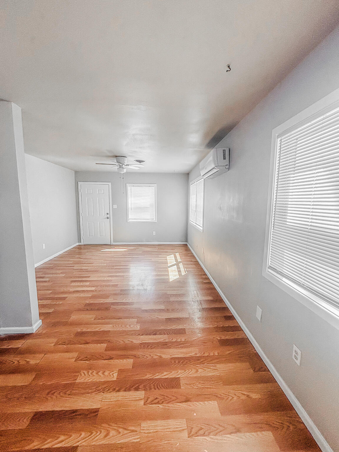 505 East 37th Street Lubbock, TX 79404 - Photo 12 of 25 a view of empty room with wooden floor and fan