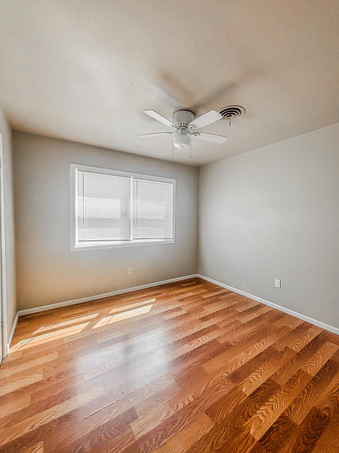 505 East 37th Street Lubbock, TX 79404 - Photo 16 of 25 a view of empty room with wooden floor and fan
