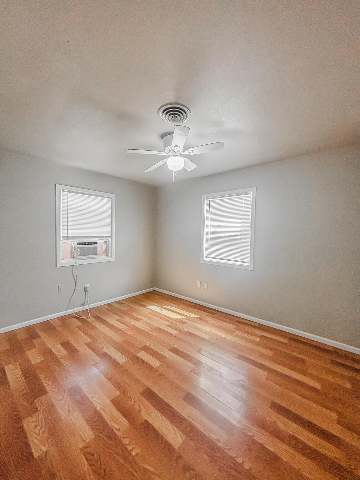 505 East 37th Street Lubbock, TX 79404 - Photo 20 of 25 a view of an empty room with wooden floor and a window