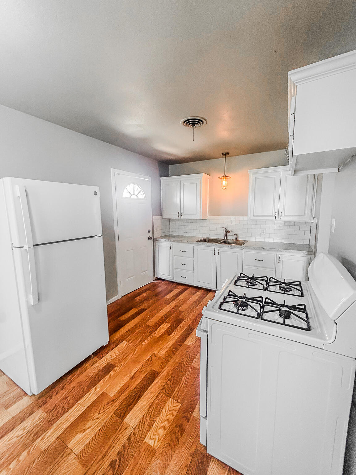 505 East 37th Street Lubbock, TX 79404 - Photo 7 of 25 a kitchen with stainless steel appliances granite countertop a refrigerator a sink and a stove
