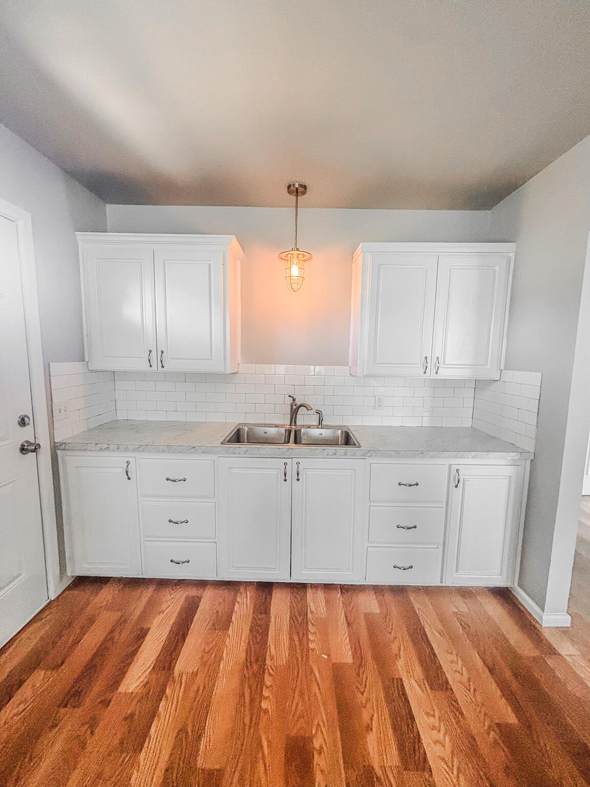 505 East 37th Street Lubbock, TX 79404 - Photo 8 of 25 a kitchen with granite countertop white cabinets and white appliances